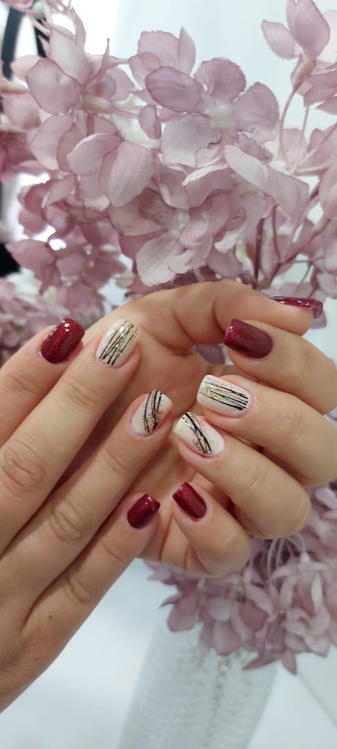 Nail technician painting a client’s nails
